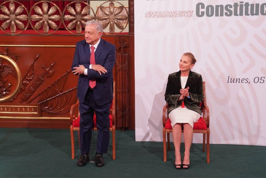 López Obrador makes a hugging gesture during a political event