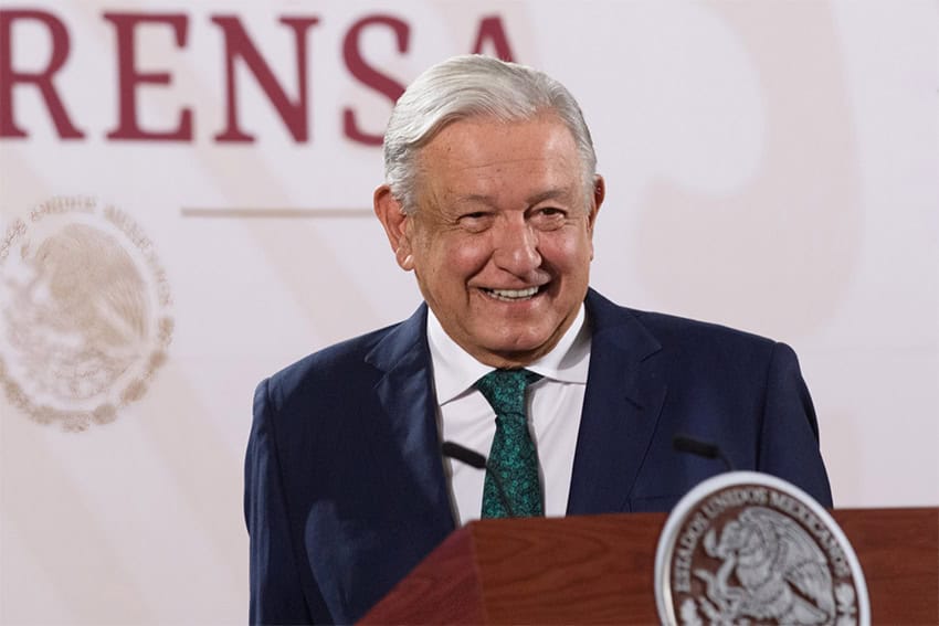 Mexican President Andres Manuel Lopez Obrador standing at a podium during a press conference