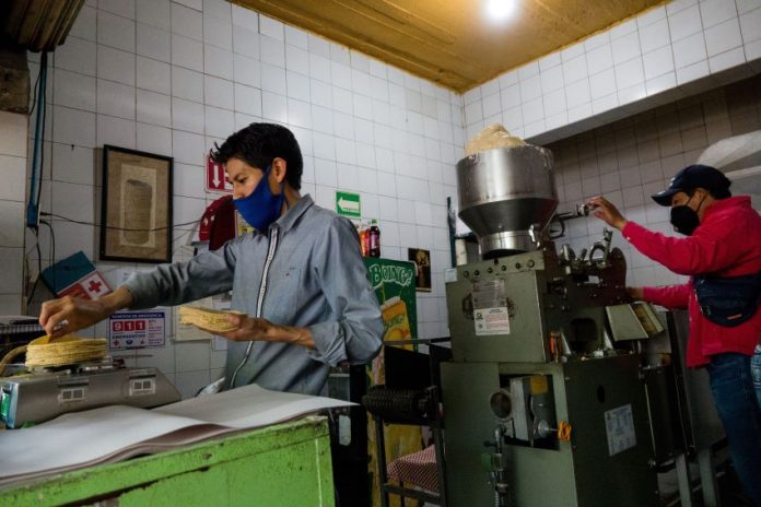 Mexicans working hard in a tortilla shop