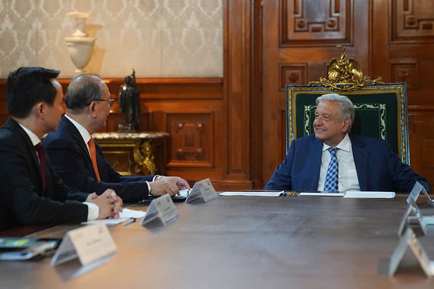 Mexico's president and two representatives of China's government sitting at a conference table