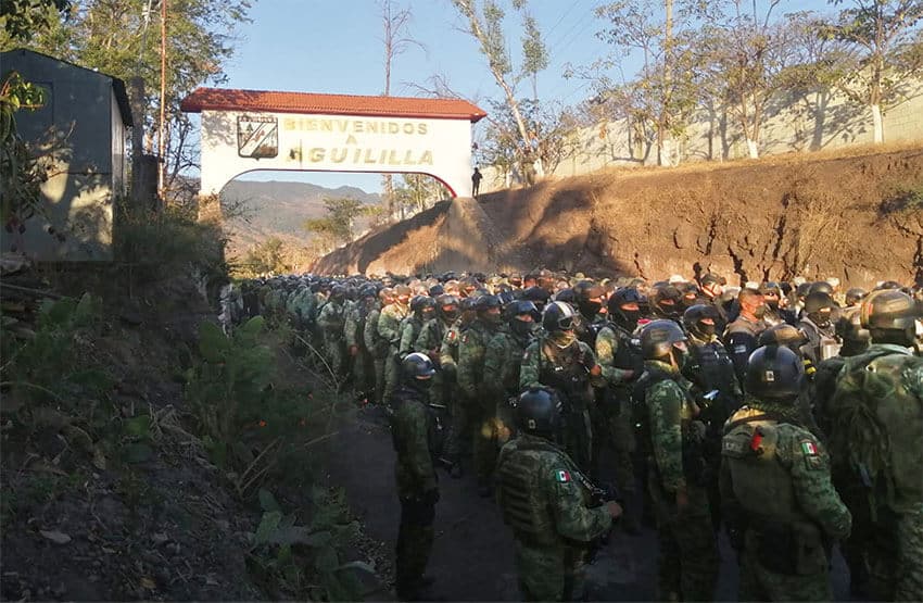 Soldiers stand at the entrance to Aguililla, in a photo shared by the National Defense Ministry on Wednesday.