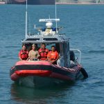 Members of Mexico's Navy travel on a rescue boat