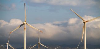 Modern windmills along a mountainous backdrop in Oaxaca, Mexico